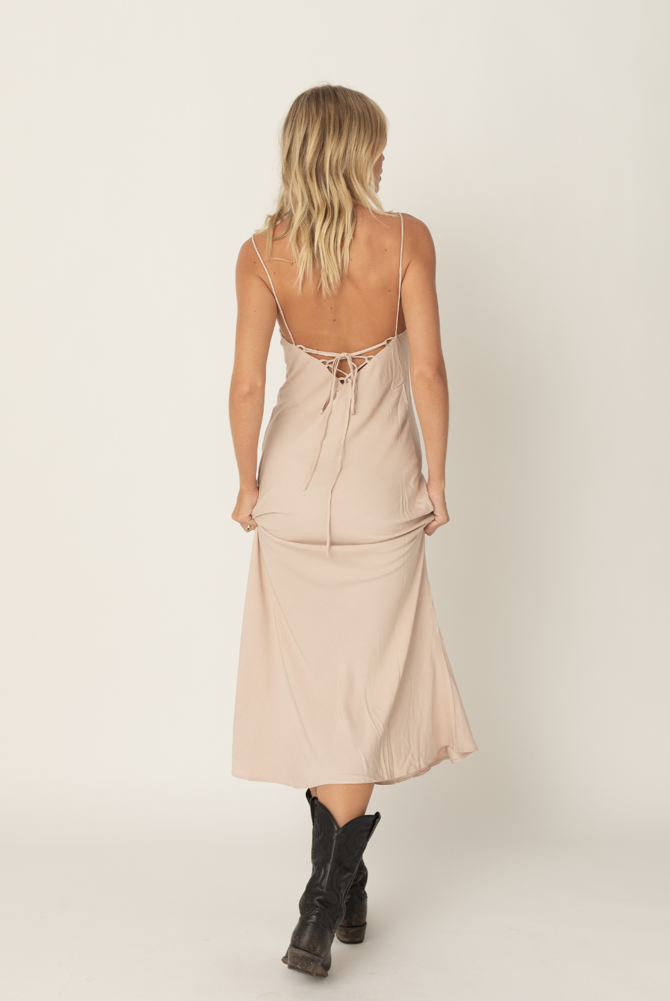 Bias cut midi slip in ballet pink with a flattering silhouette and a tie back detail for an adjustable fit. The perfect slip in our signature eco friendly fabric.