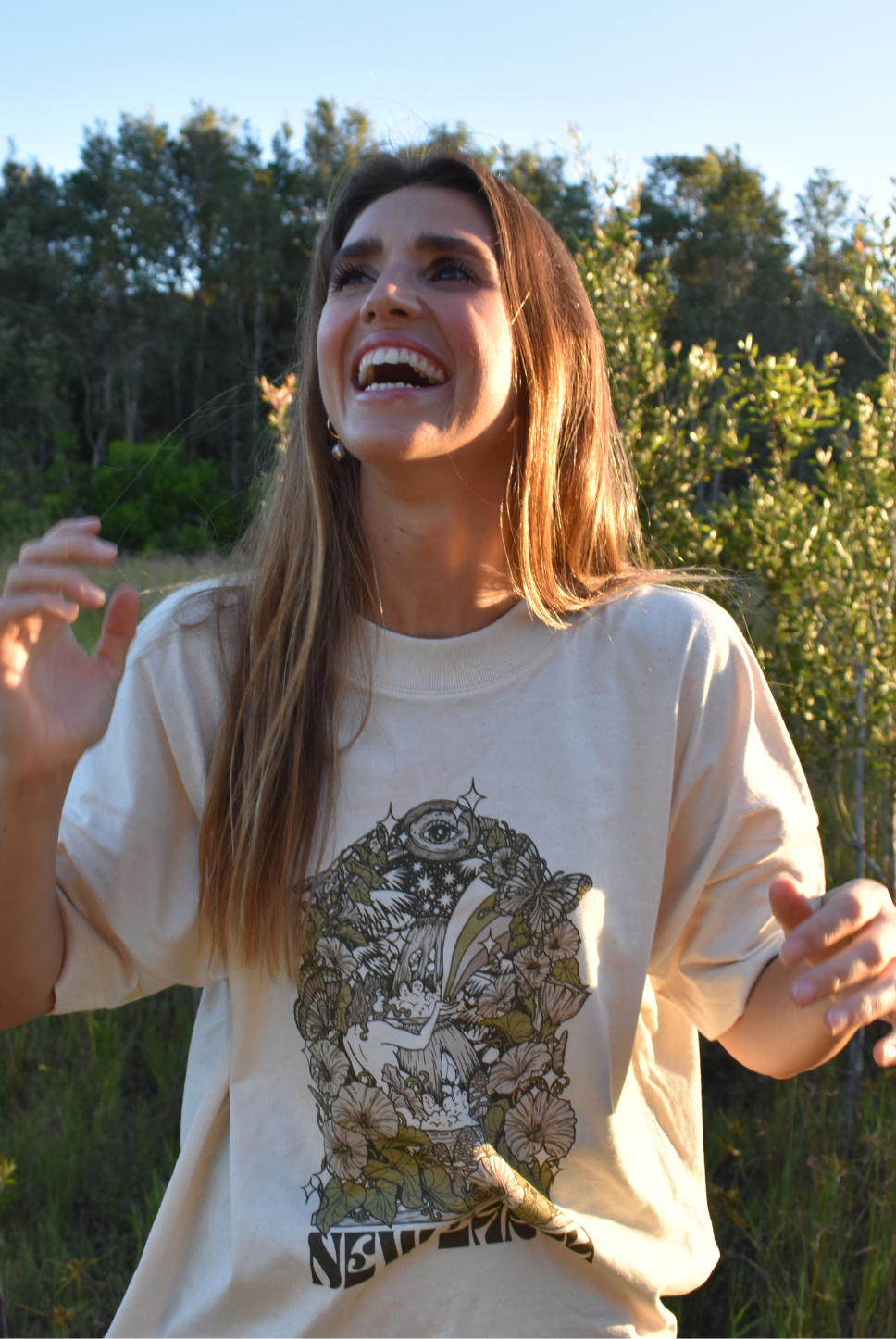 Oversized t-shirt. Beach tee. Unisex. Natural raw colour. New Earth graphic and letters. Coloured flowers. Waterfall. Garden tee