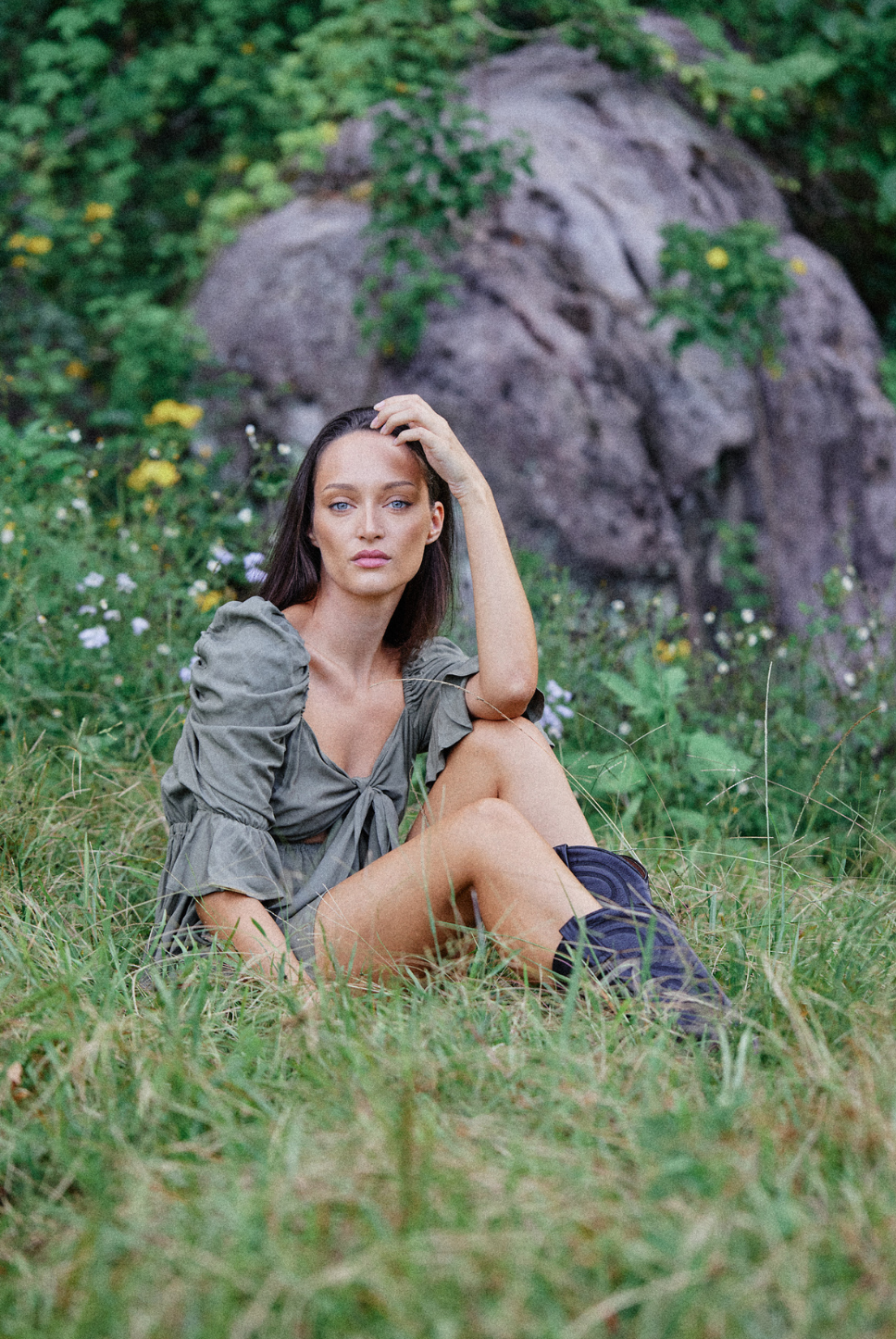Khaki green mini empire waist dress with a bow tie enclosure in the front. Elastic bust and sleeves for a forgiving fit. Can be worn off the shoulder or backwards. Is breastfeeding and bust friendly.